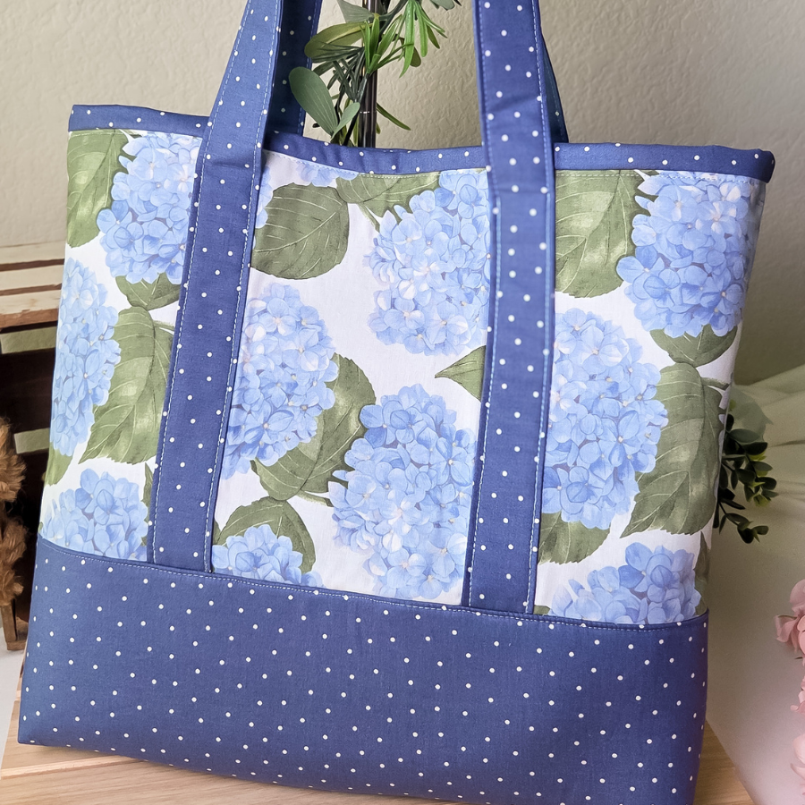 Tote bag with blue floral pattern on a wooden surface