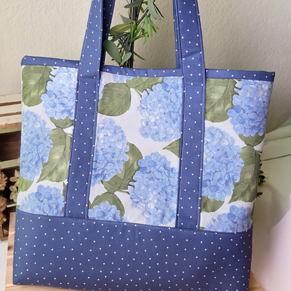 Tote bag with blue floral pattern on a wooden surface