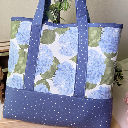 Tote bag with blue floral pattern on a wooden surface